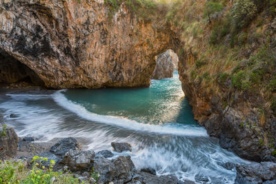 Rock formations by seashore