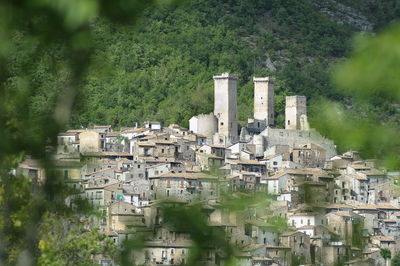 High angle view of buildings against mountain in town