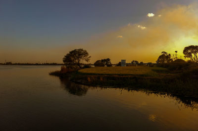 Scenic view of lake against sky during sunset