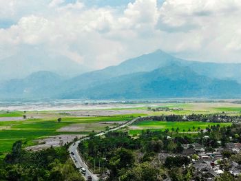 Scenic view of agricultural landscape against sky