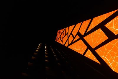 Low angle view of illuminated building against sky at night