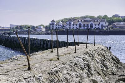 Scenic view of sea by buildings against sky