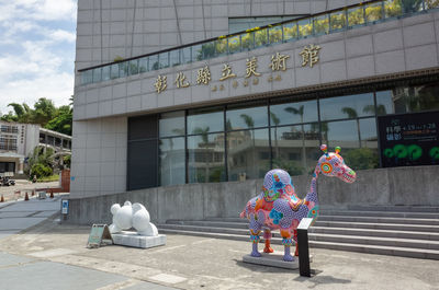 Toy car on street against building in city