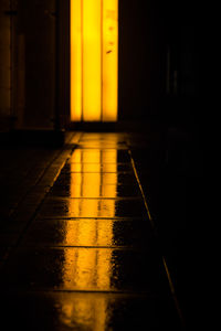 Low angle view of hallway with yellow light