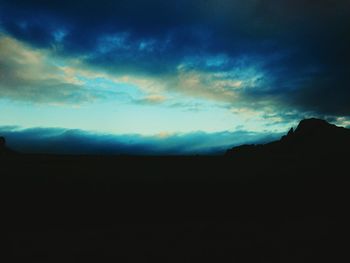 Scenic view of mountains against cloudy sky