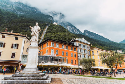 Group of people on building by mountain against sky