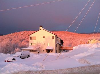 House on snow covered landscape