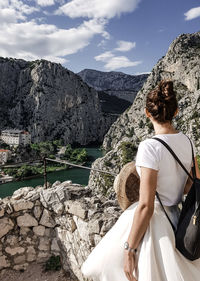 Woman standing against mountains