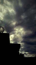 Low angle view of building against cloudy sky