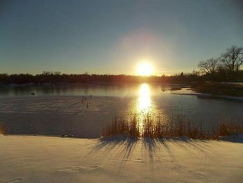 Scenic view of lake at sunset