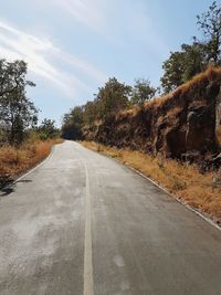 Surface level of empty road against sky