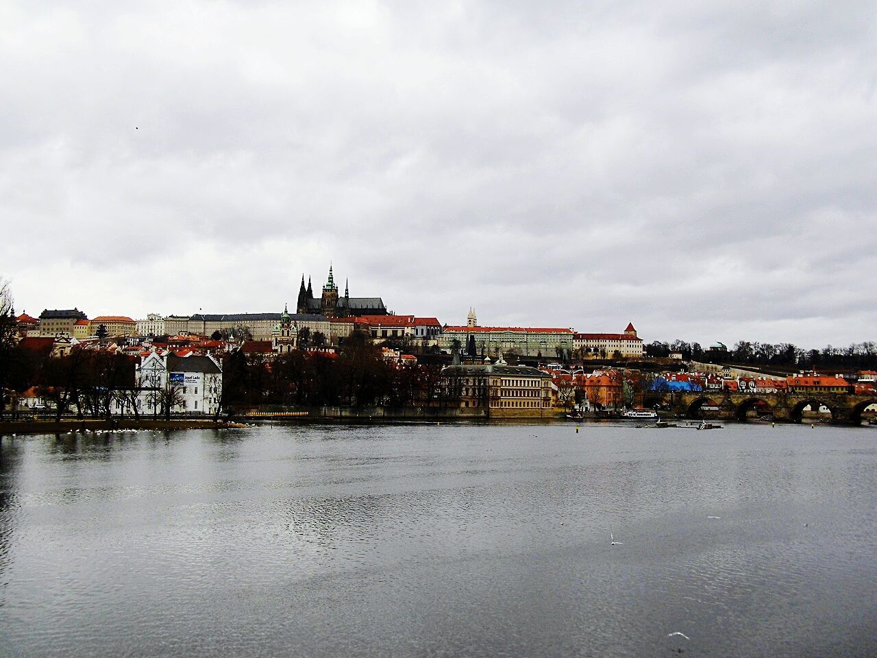 architecture, building exterior, built structure, water, sky, cloud - sky, waterfront, cloudy, residential structure, city, residential building, river, cloud, residential district, house, town, overcast, sea, nautical vessel, weather