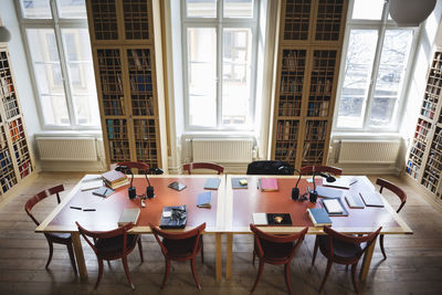 High angle view of empty chairs with table in board room at law library