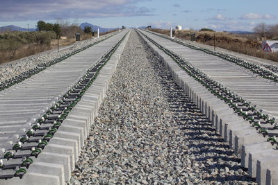 Surface level of railroad tracks against sky