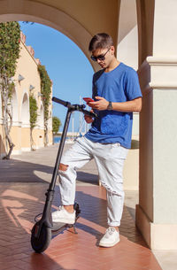 Full length of man standing against wall