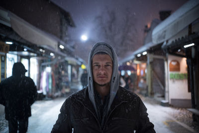 Portrait of young man standing in snow