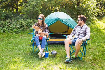 Young couple sitting on swing