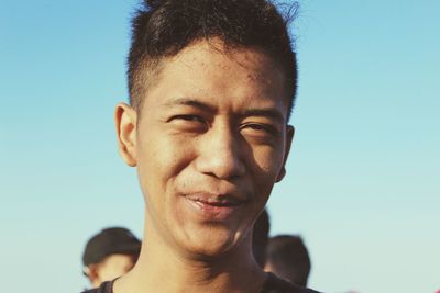 Portrait of young man against clear sky