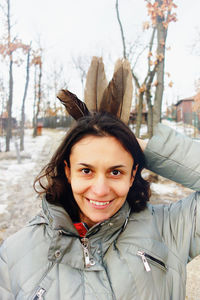 Portrait of smiling young woman standing outdoors