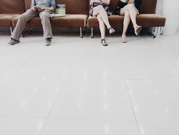 Low section of people sitting on sofa