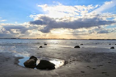 Scenic view of beach against sky during sunset