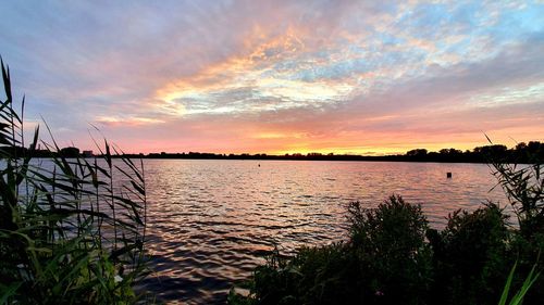 Scenic view of lake against sky during sunset