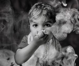 Portrait of girl blowing dandelion