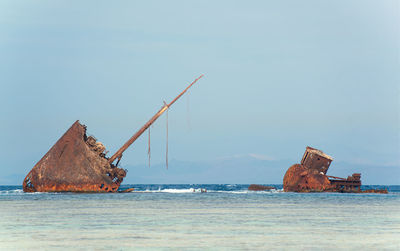Scenic view of rusty ship against clear sky