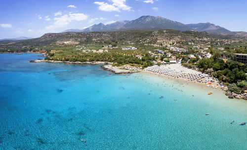 Scenic view of sea and mountains against sky