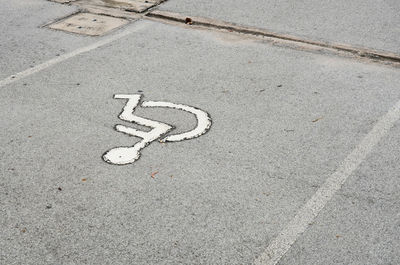 High angle view of arrow sign on road