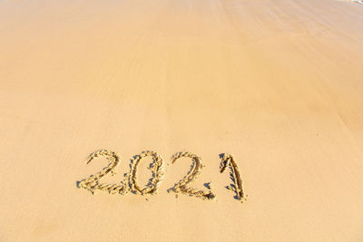 Text written on sand at beach