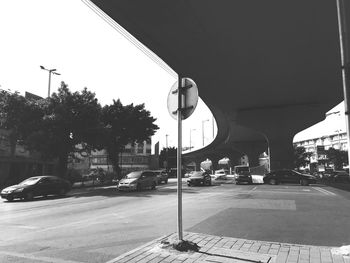 Cars on road in city against sky