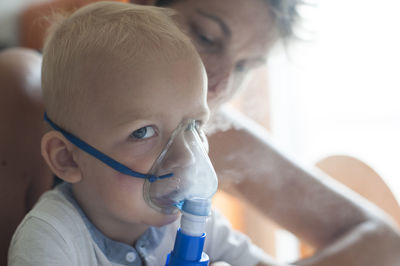 Close-up portrait of boy inhaling