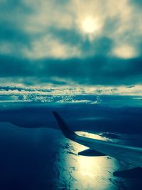 Cropped image of airplane flying over sea