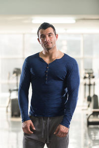 Muscular man standing in gym