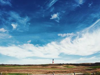 Scenic view of lighthouse against cloudy sky