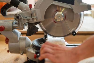 Cropped hands of man working in factory