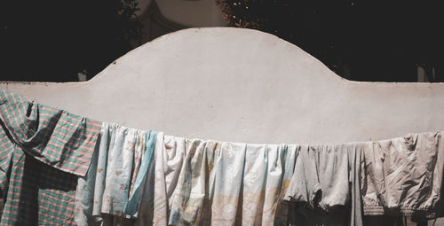 Close-up of clothes drying against white wall