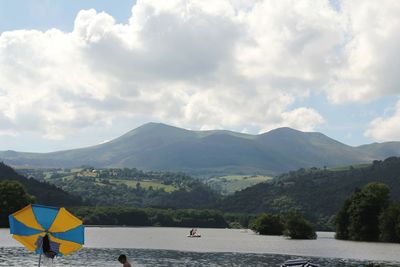 Scenic view of mountains against cloudy sky