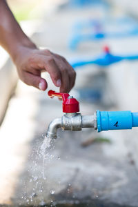 Close-up of hand holding red water