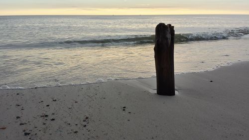 Scenic view of beach against sky during sunset