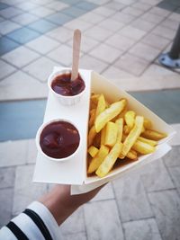 Cropped hand of woman holding food