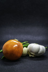 Close-up of oranges on table against black background