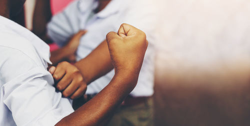 Midsection of couple holding hands