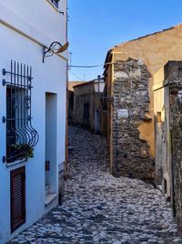 Street amidst buildings against sky