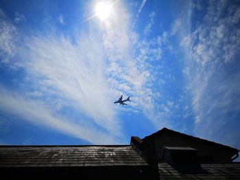 Low angle view of airplane flying in sky