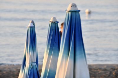 Close-up of deck chairs on beach