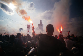 REAR VIEW OF PEOPLE IN FRONT OF BUILDING