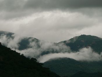 Scenic view of mountains against cloudy sky