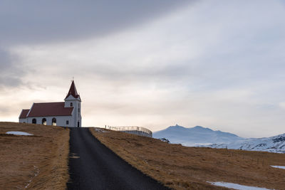 View of church by building against sky